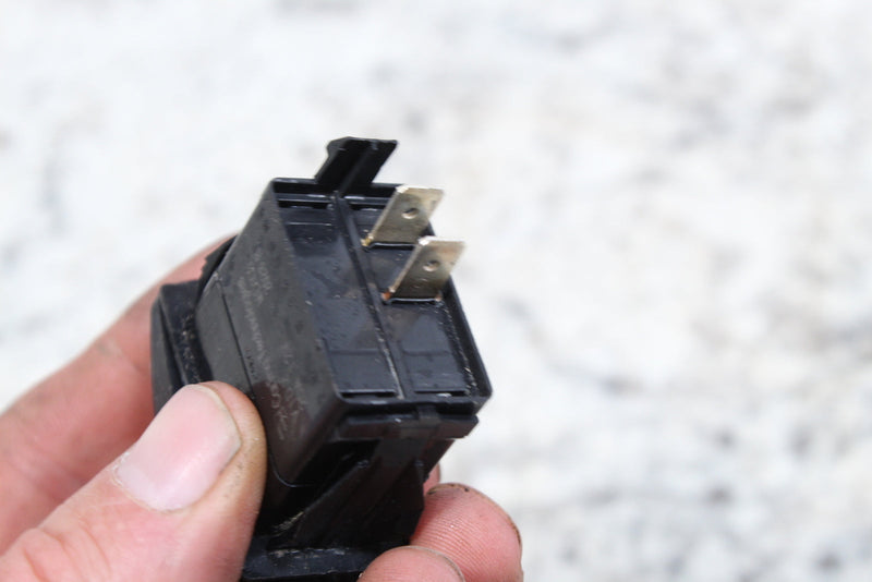Black electrical switch with metal terminals.