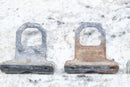 Two metal brackets with rust.