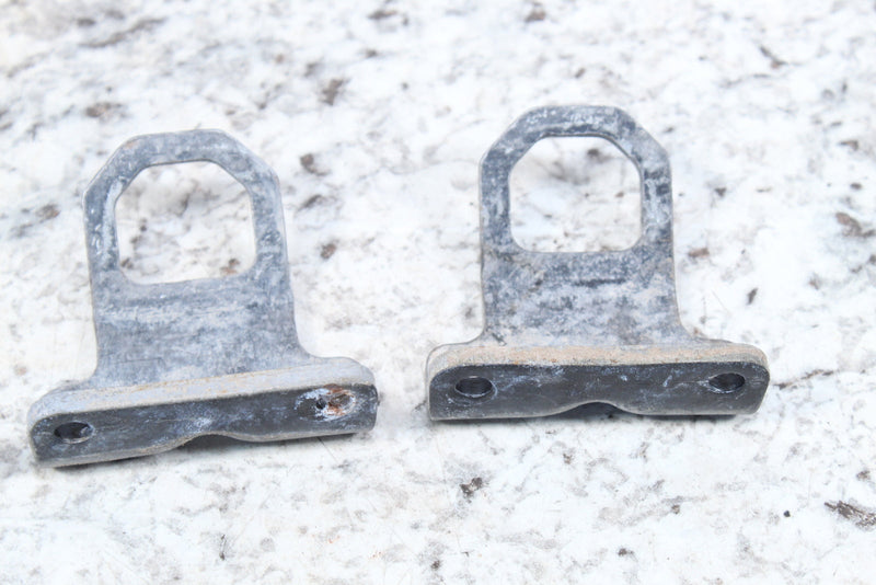 Two weathered metal brackets.