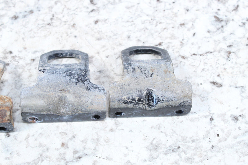 Dirty, metal, T-shaped brackets.