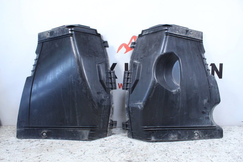 Two black plastic air filter housings.
