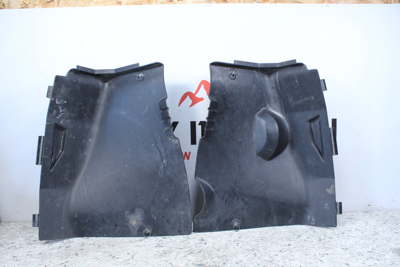Two black plastic car interior panels.