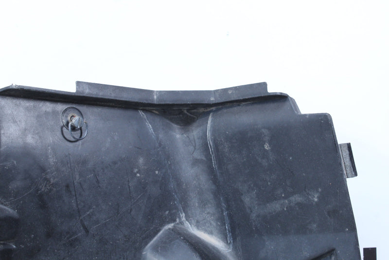 Black plastic tractor part.