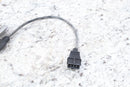 Black electrical connector with attached wire.