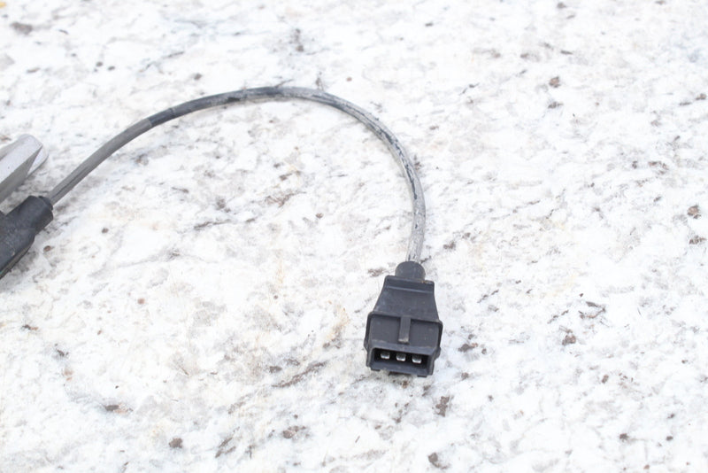 Black electrical connector with attached wire.