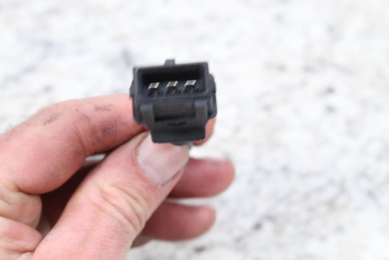 Black electrical connector with four pins.