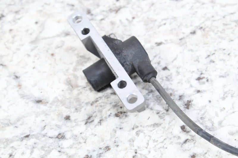 Black sensor with silver mounting bracket and gray wire.