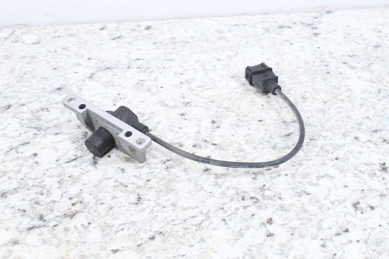 Black and silver sensor with electrical connector.