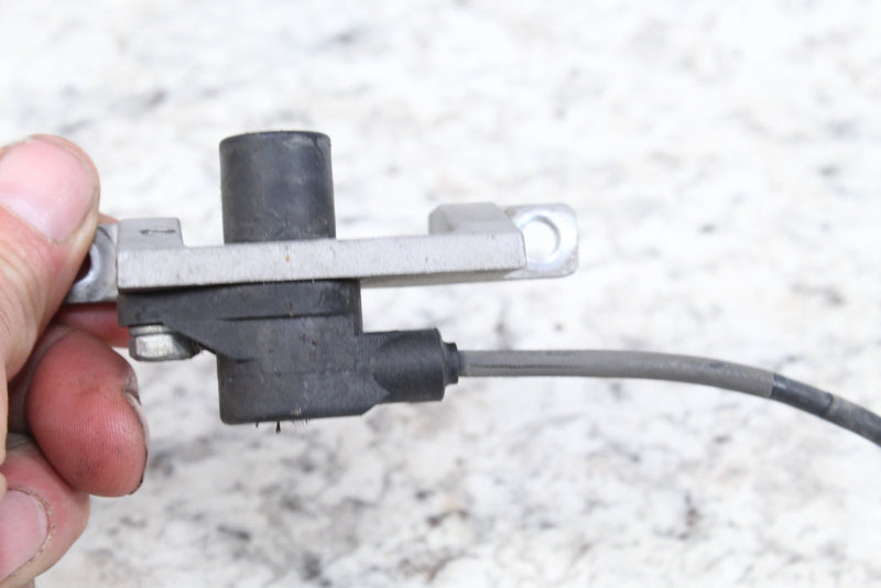 Black and silver sensor with attached wire.