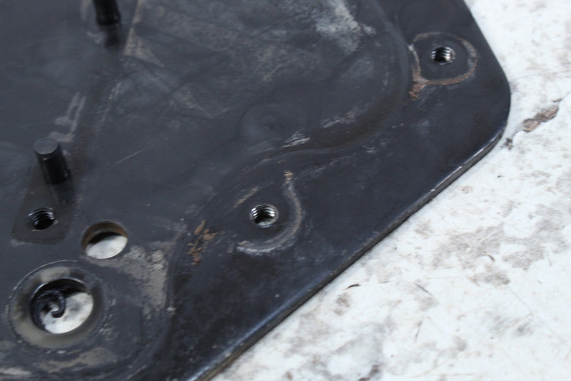 Black metal plate with mounting holes.