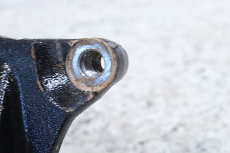 Black metal part with threaded hole.