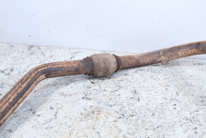 Rusted exhaust pipe with catalytic converter.