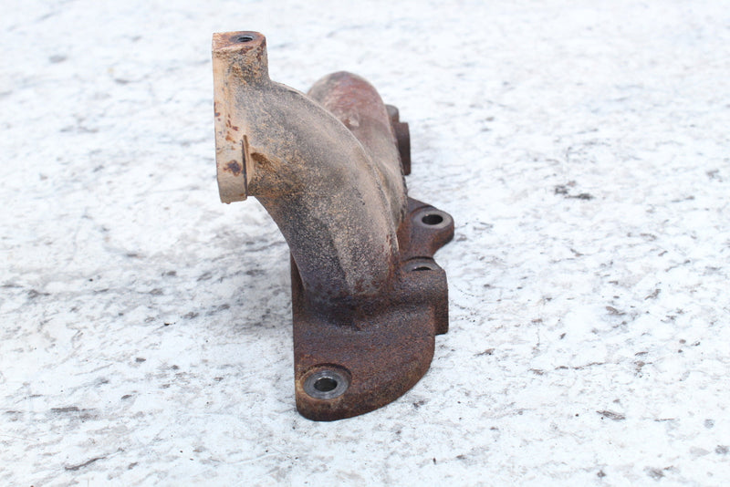 Rusty, cast metal exhaust manifold.