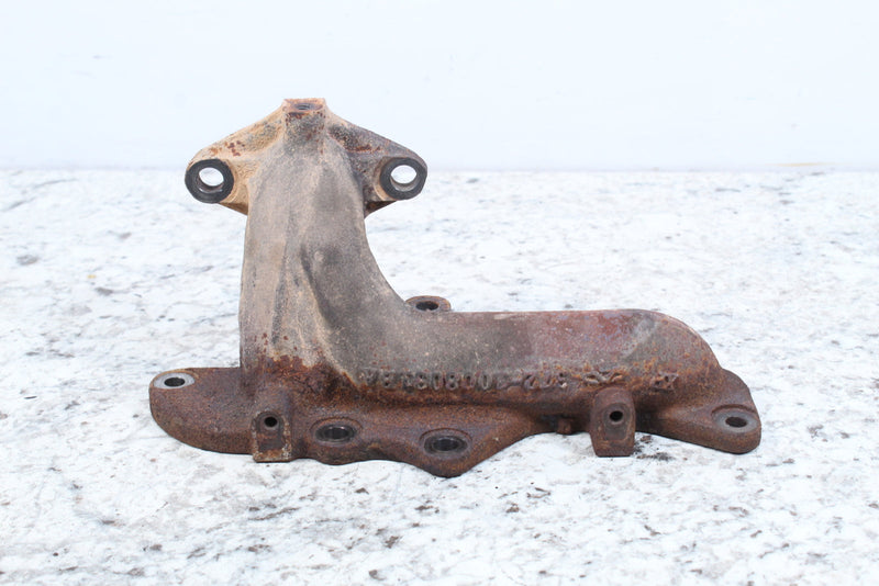 Rusty, cast metal exhaust manifold.