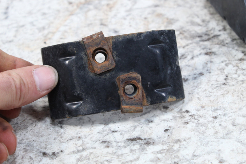 Black metal bracket with rusty fasteners.