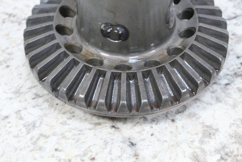 Metal bevel gear with drilled holes.