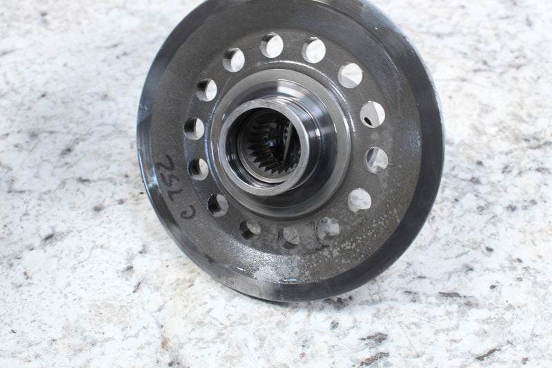 Metal gear component with circular perforations.