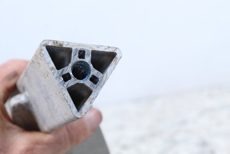 Triangular aluminum extrusion with internal voids.