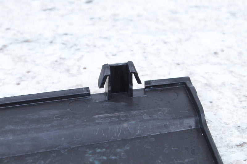 Black plastic trim piece with clip.