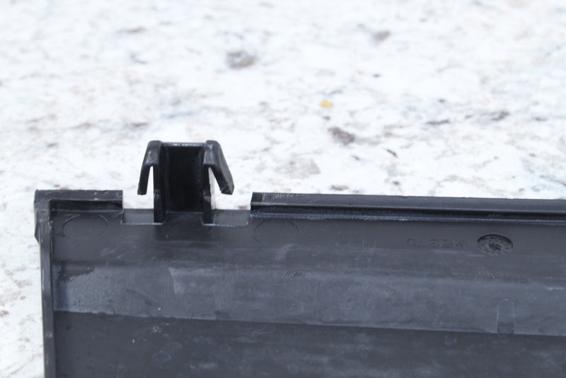 Black plastic component with clip.