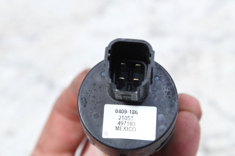Black electrical component with a four-prong connector.