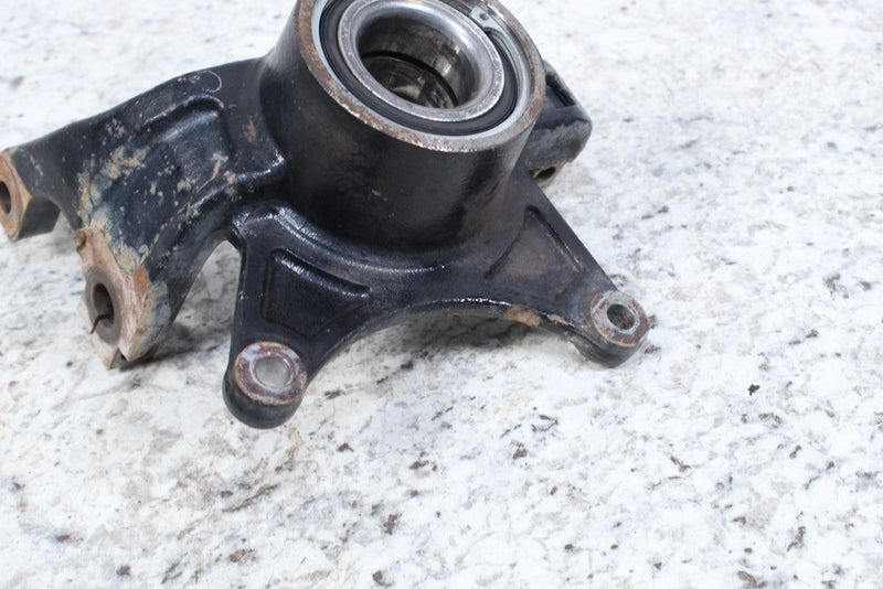 Black metal automotive part with bearing.