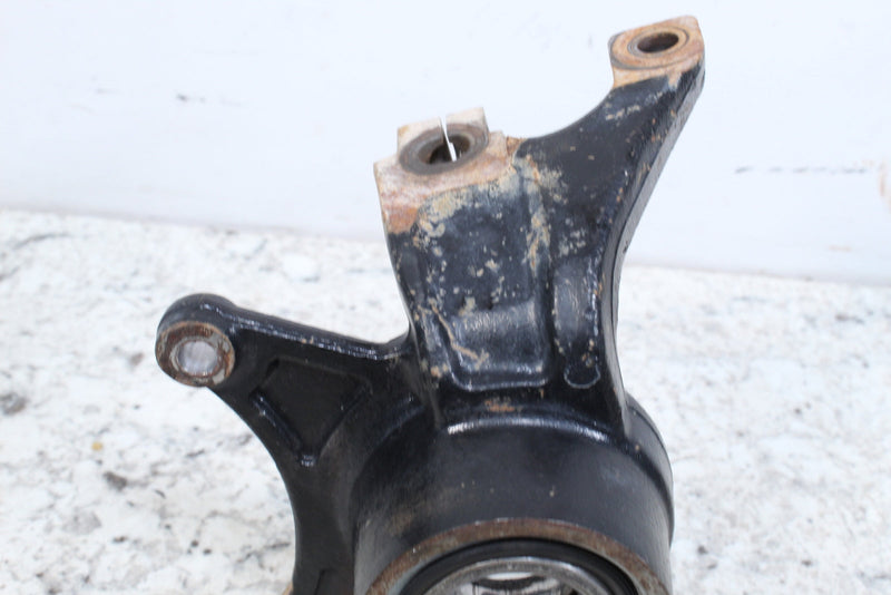 Black metal steering knuckle.