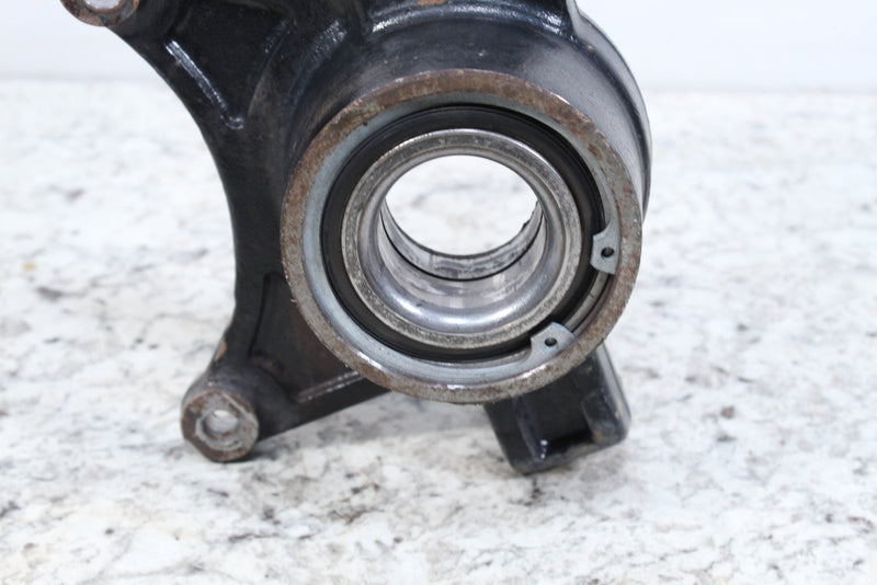 Black metal steering knuckle.