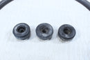Three used rubber bushings.