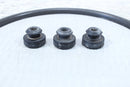 Three black rubber bushings and a black rubber ring.