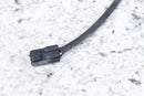 Black electrical connector with attached wire.
