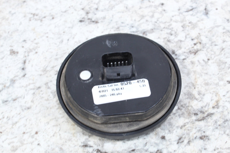Round black gauge with electrical connector.