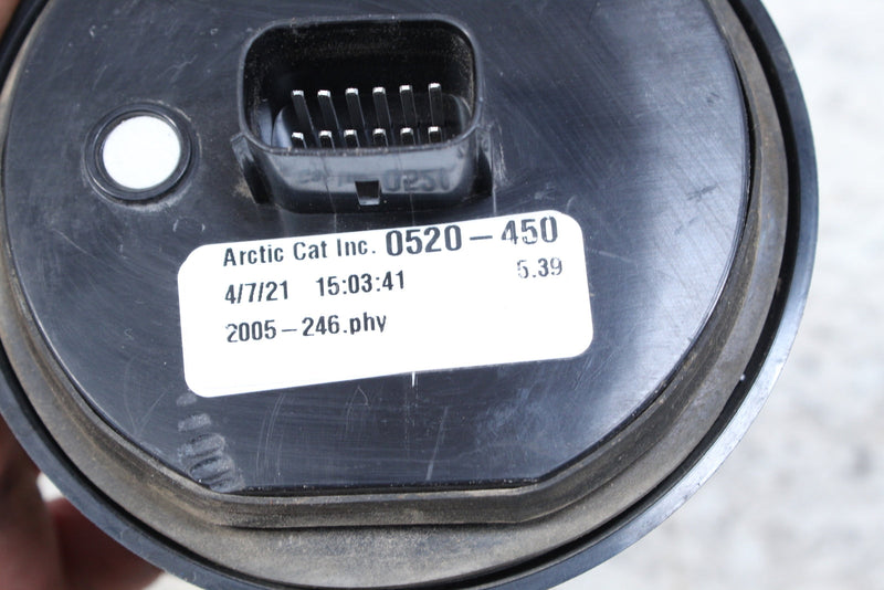 Round black gauge with a connector and a label.