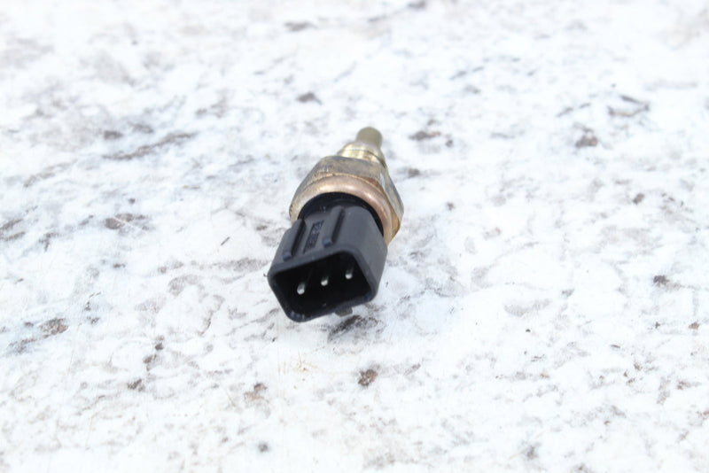 Three-pronged black connector with brass-colored sensor.