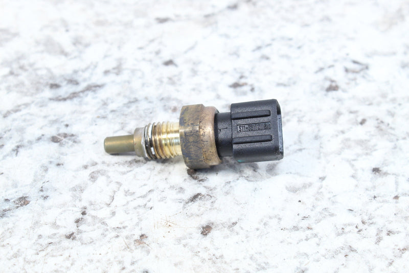 Brass and black temperature sensor.