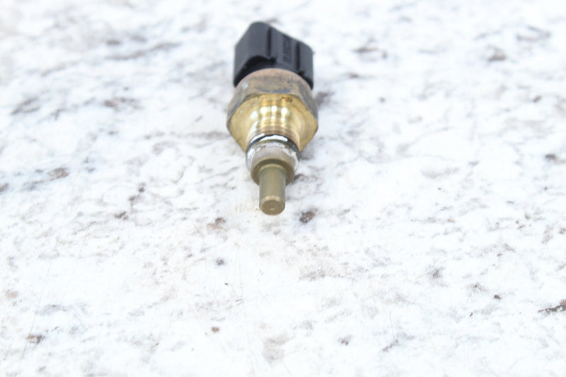 Brass-colored temperature sensor with black connector.