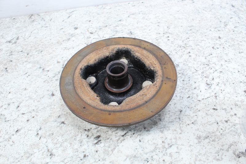 Worn, circular metal brake rotor with central splined hub.