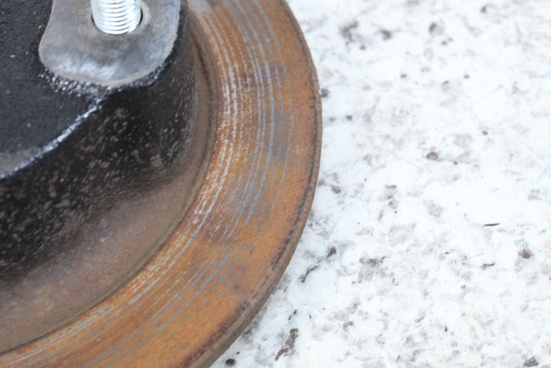 Rusted, grooved brake rotor.