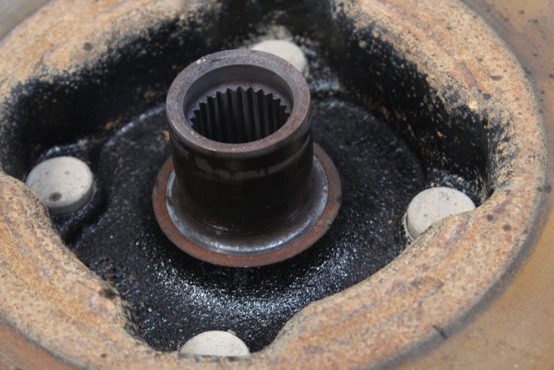 Splined metal shaft with rust.
