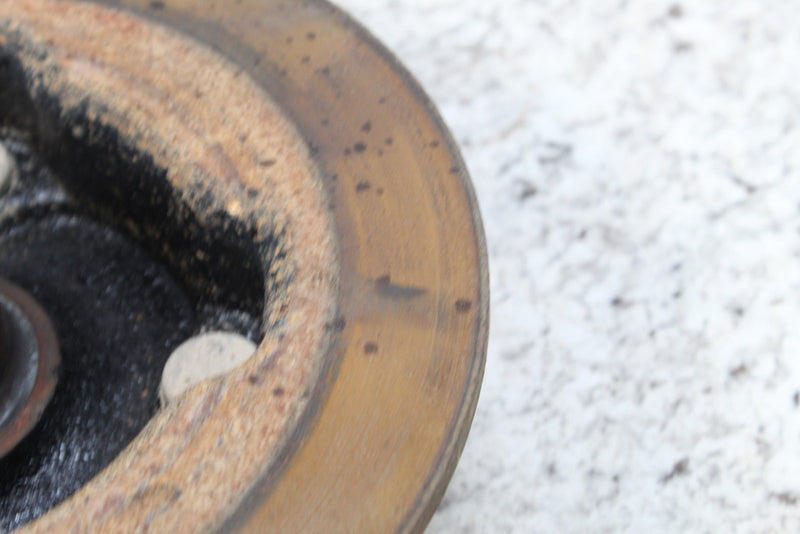 Worn, rusty brake rotor.
