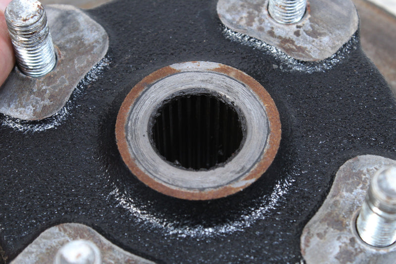 Black metal hub with splined center.
